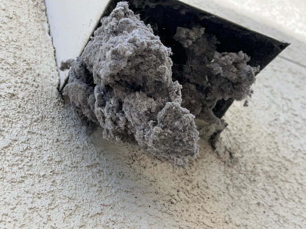 Heavy dryer lint overflow removed during vent cleaning in Oakland, CA Heavy dryer lint overflow removed during vent cleaning in Oakland, CA