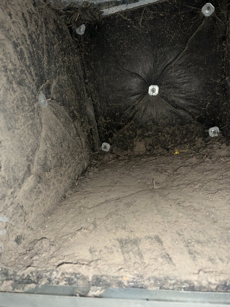 Dirty black insulation inside HVAC ducts before cleaning in Oakland, CA Dirty black insulation inside HVAC ducts before cleaning in Oakland, CA