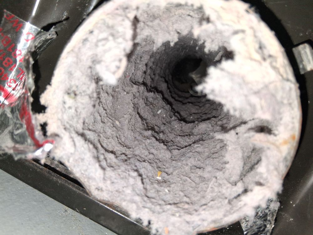 Coated vent tube buildup before air duct restoration in Oakland, CA Coated vent tube buildup before air duct restoration in Oakland, CA